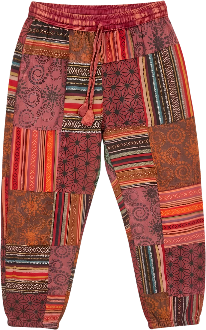 Madder Quilt — red and rust square-patchwork trousers.